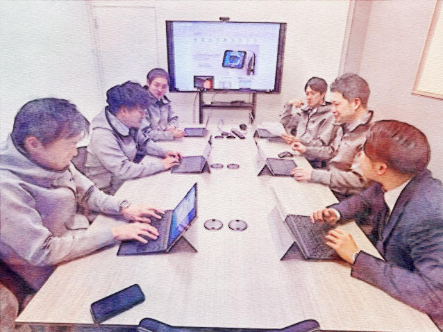 TOMEYの営業スタッフが、製品販売の戦略を共有し議論している。