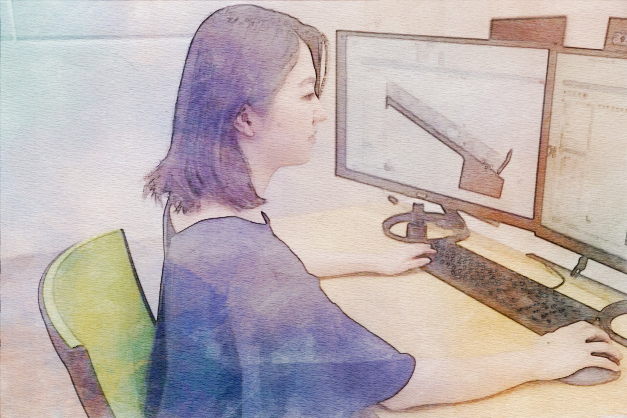 TOMEY技術部スタッフが、眼科機器の設計図をPCで設計している。